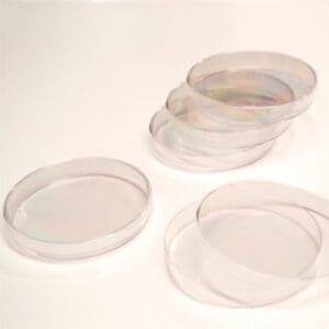 Stack of clear plastic petri dishes used in laboratories.